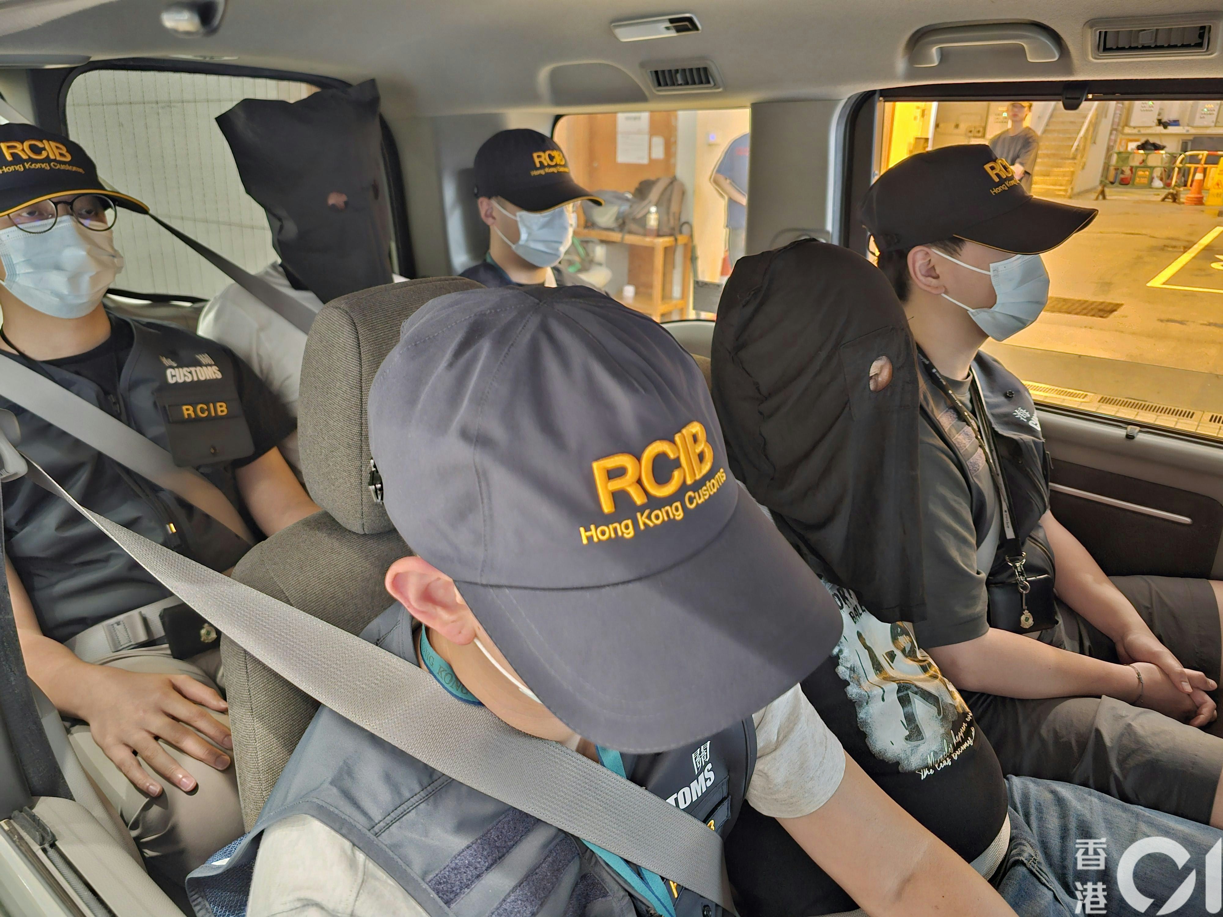 两名被捕内地男子在海关人员押解下离开现场